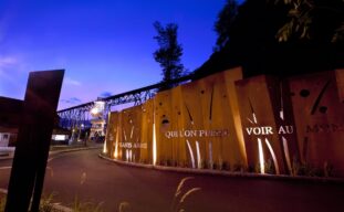 La Commission a travaillé à l'édification du mur mémoire Cartier-Roberval au pied de la falaise qui a vu naître la première colonie française d'Amérique. Le mur mémoire Cartier-Roberval se veut un geste artistique et commémoratif inspiré du lieu et de son histoire. La forme du mur évoque le fracas des vagues sur ce cap et ce rivage il y a près de cinq siècles. Les mots de Cartier et de Roberval qui le parsèment rappellent la volonté de la France de s'installer à demeure au Nouveau Monde. Le choix du matériau fait aussi écho au riche passé du site, qu'il s'agisse de la découverte d'une mine de fer sur place par Cartier ou de la construction de l'imposant « tracel », toujours omniprésent dans le paysage, au siècle dernier. Le design du mur mémoire a été réalisé par Plania, firme d'urbanisme et d'architecture de paysage.